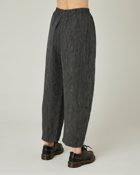 model wears black and ecru pencil stripe linen mabel trousers right