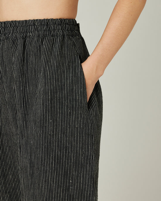 model wears black and ecru pencil stripe linen mabel trousers