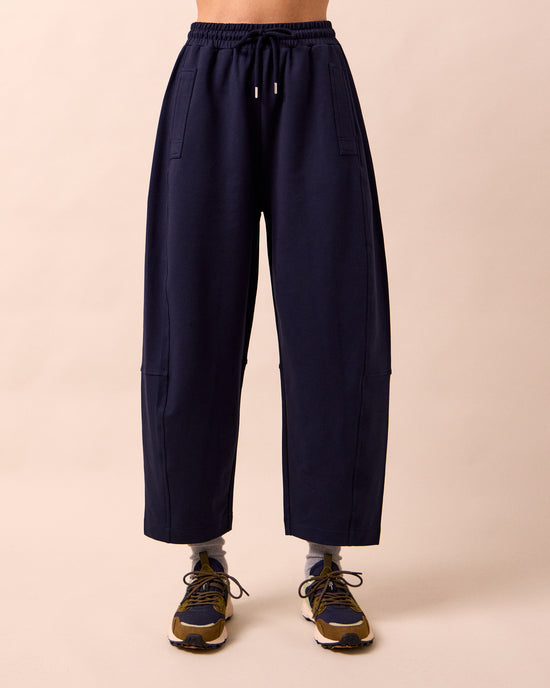 model wears madi ink jersey trousers front