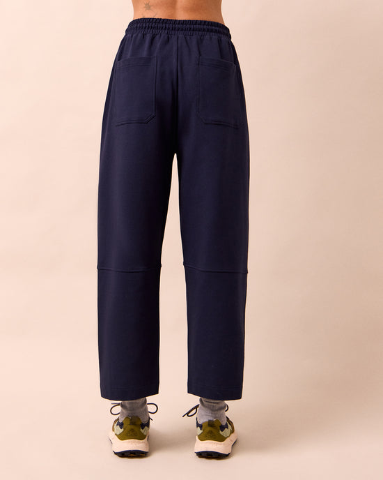 model wears madi ink jersey trousers back