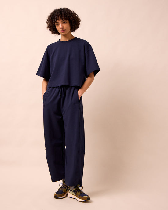 model wears madi ink jersey trousers right