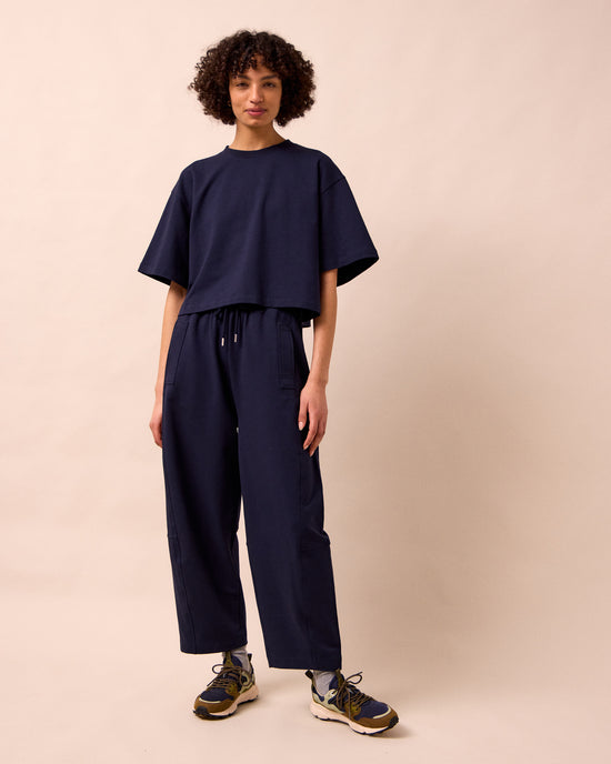 model wears madi ink jersey trousers left