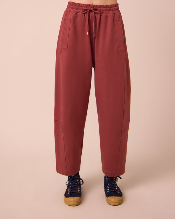 model wears madi brick jersey trousers front