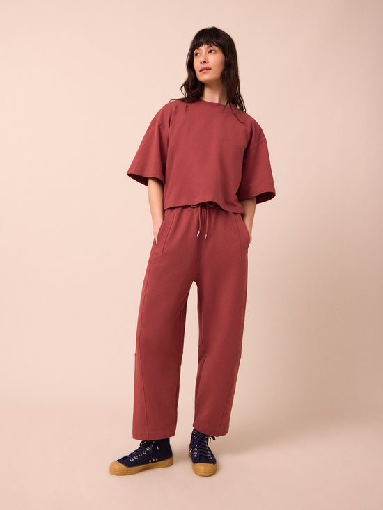 model wears madi brick jersey trousers right