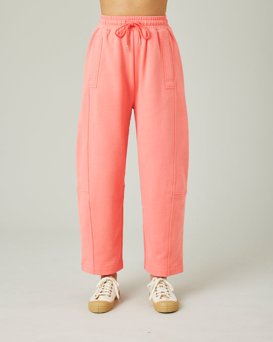 model wears shrimp pink madi trousers front