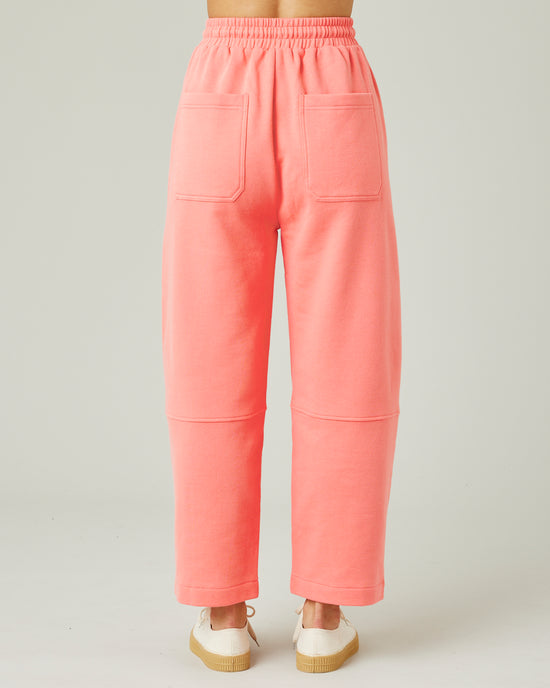 model wears shrimp pink madi trousers back