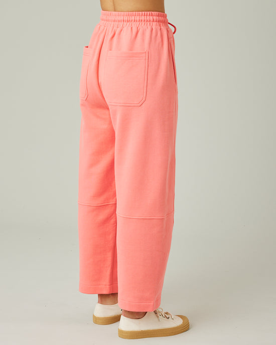 model wears shrimp pink madi trousers right 