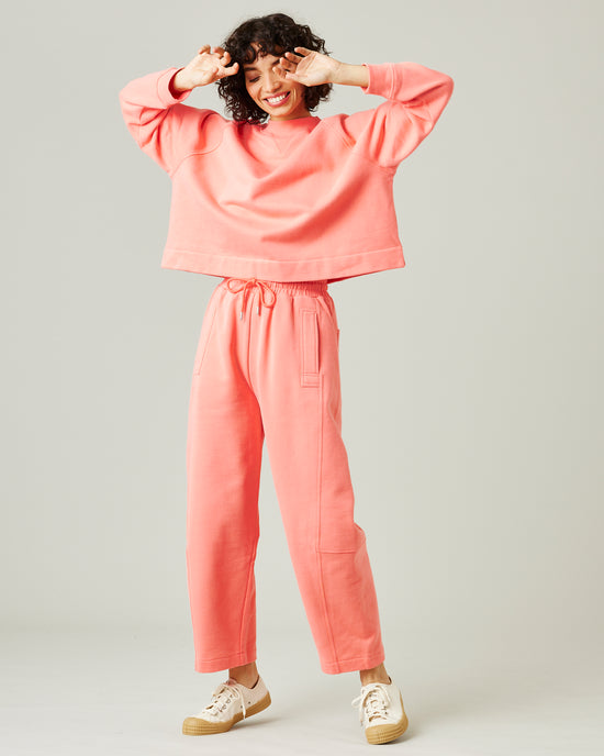 model wears shrimp pink madi trousers 