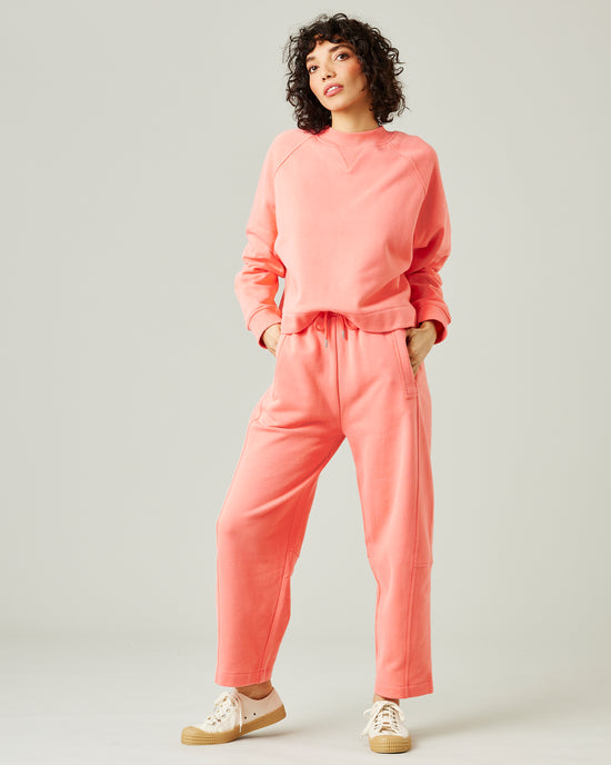 model wears shrimp pink madi trousers 