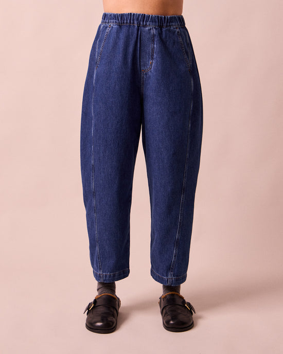 model wears maeve mid blue denim trousers front