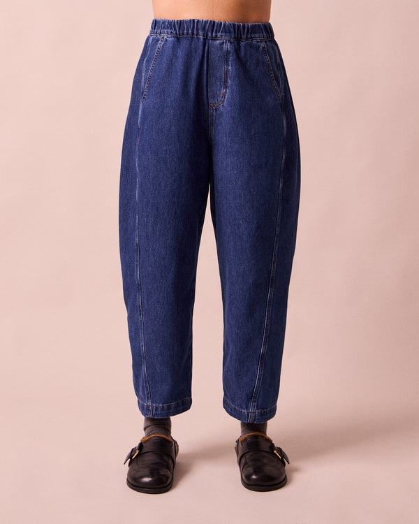 model wears maeve mid blue denim trousers front