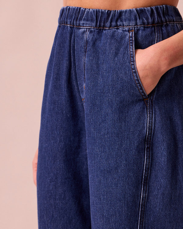 model wears maeve mid blue denim trousers