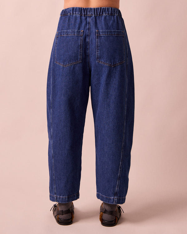 model wears maeve mid blue denim trousers back