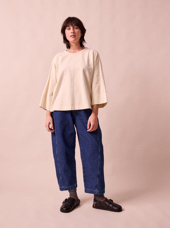 model wears maeve mid blue denim trousers right