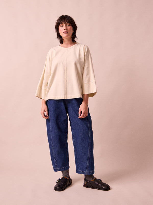 model wears maeve mid blue denim trousers right