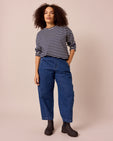 model wears maeve mid blue denim jeans front