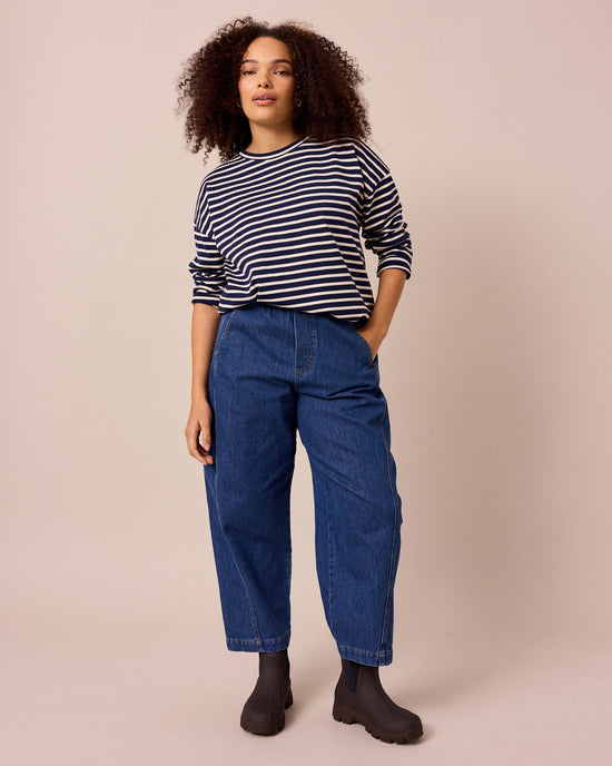 model wears maeve mid blue denim jeans front