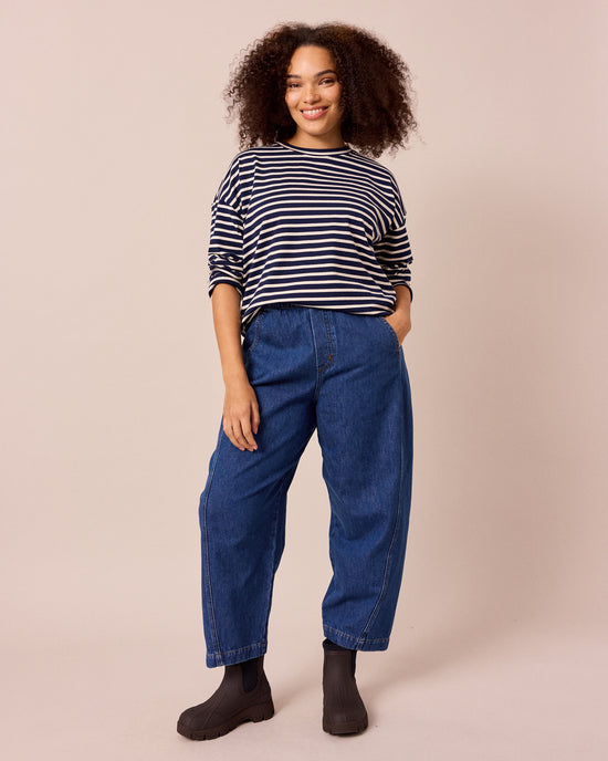 model wears maeve mid blue denim jeans left