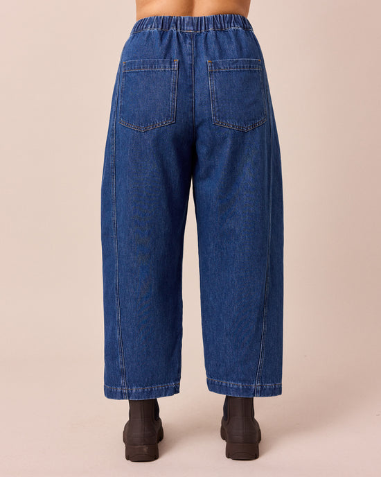 model wears maeve mid blue denim jeans right