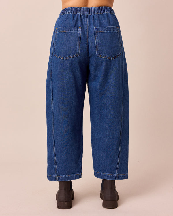 model wears maeve mid blue denim jeans right