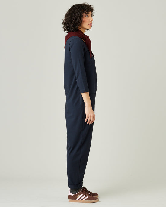 model wears navy margot jersey jumpsuit