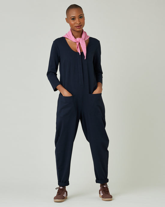 model wears navy margot jersey jumpsuit