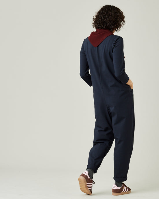 model wears navy margot jersey jumpsuit