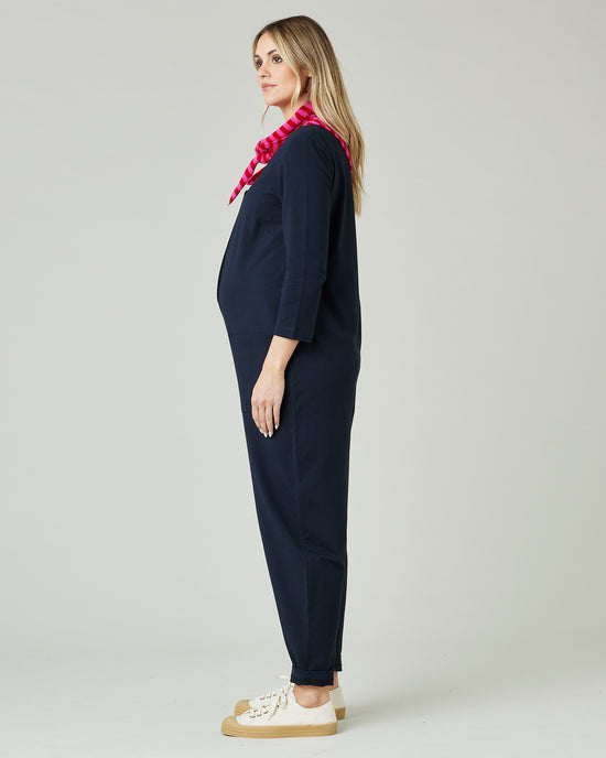 pregnant model wears navy margot jersey jumpsuit