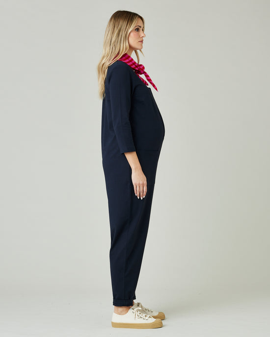 pregnant model wears navy margot jersey jumpsuit