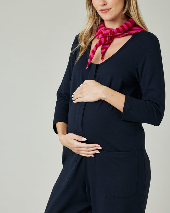 pregnant model wears navy margot jersey jumpsuit