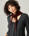 model wears knitted neckerchief in burgundy 