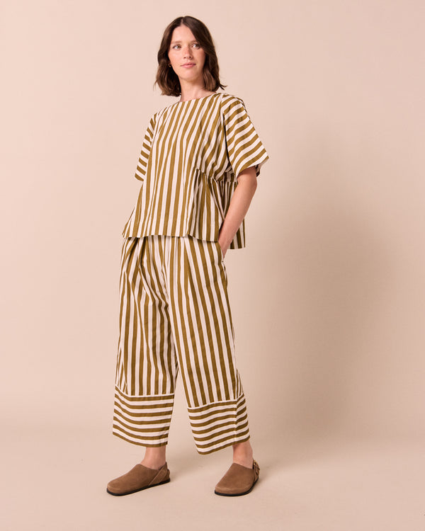 model wears marlow dune stripe poplin top.