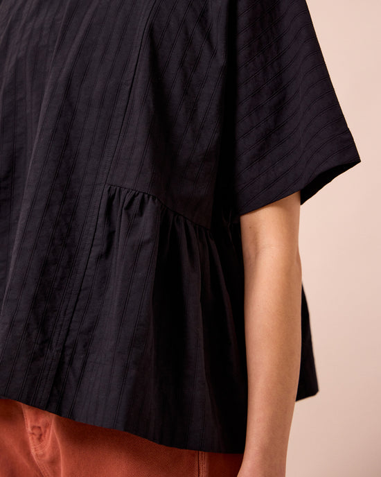 model wears marlow black self stripe cotton top