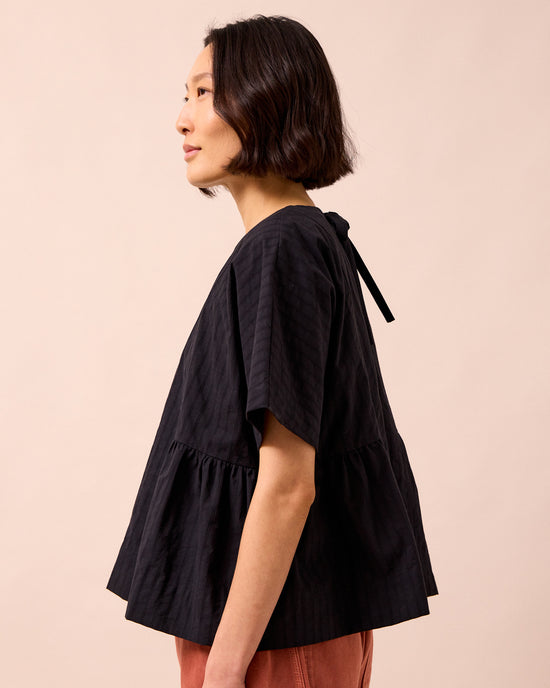 model wears marlow black self stripe cotton top