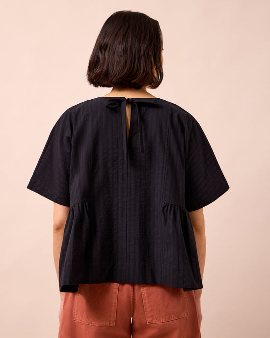 model wears marlow black self stripe cotton top