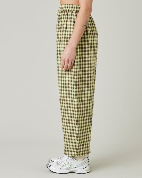 model wears matcha gingham linen mabel trousers left