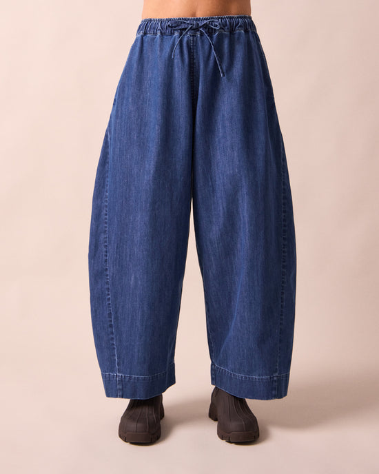 model wears mathilde mid blue denim jeans front