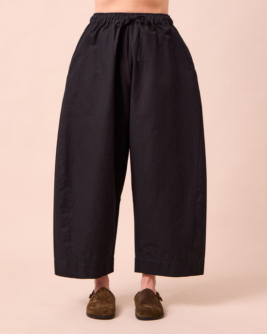 model wears mathilde black cotton linen trousers front