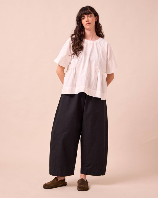 model wears mathilde black cotton linen  trousers left