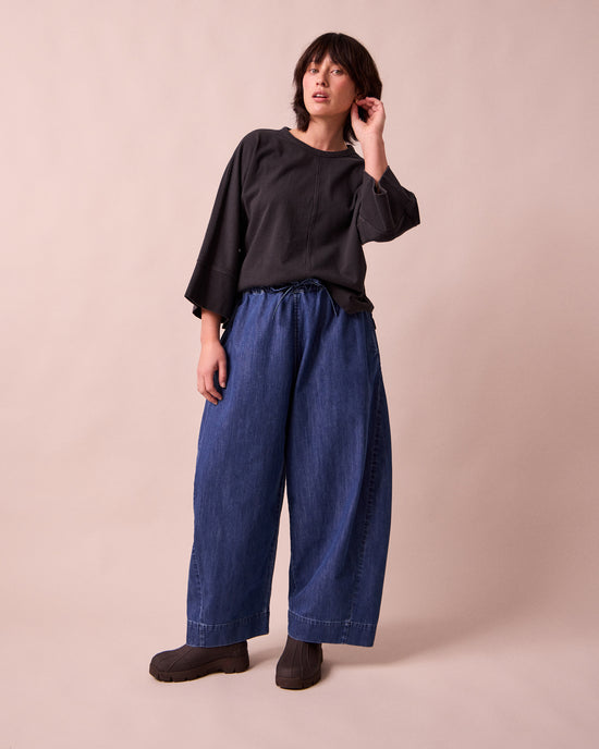 model wears mathilde mid blue denim jeans left