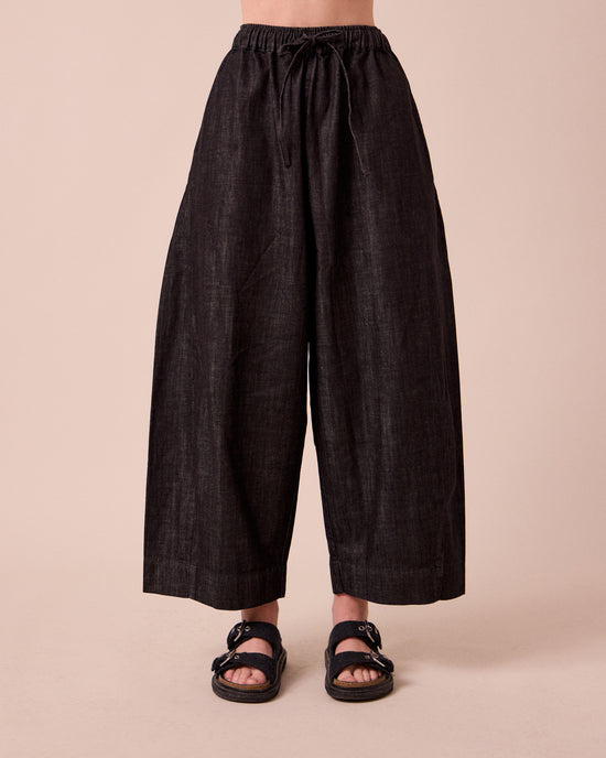 model wears mathilde washed black denim jeans front