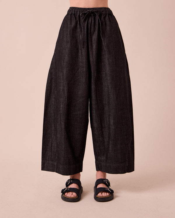 model wears mathilde washed black denim jeans front