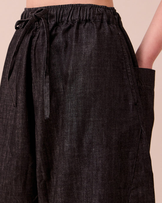 model wears mathilde washed black denim jeans