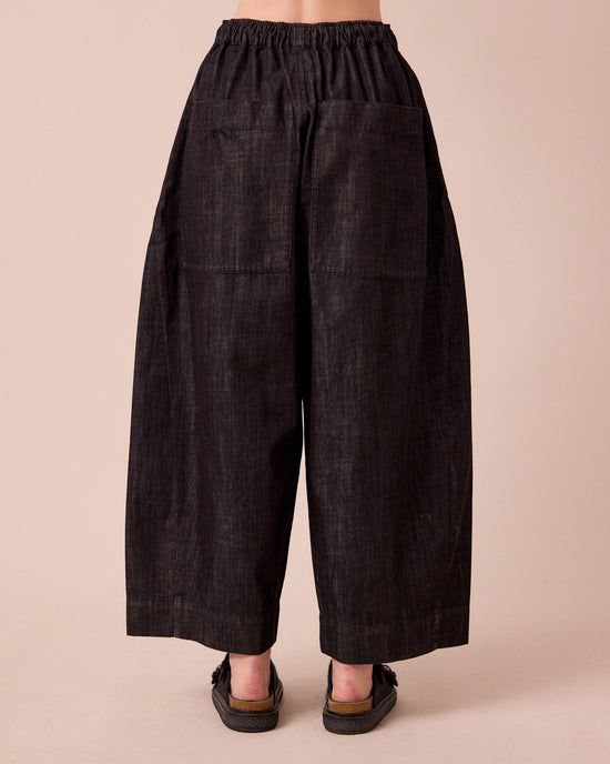 model wears mathilde washed black denim jeans back