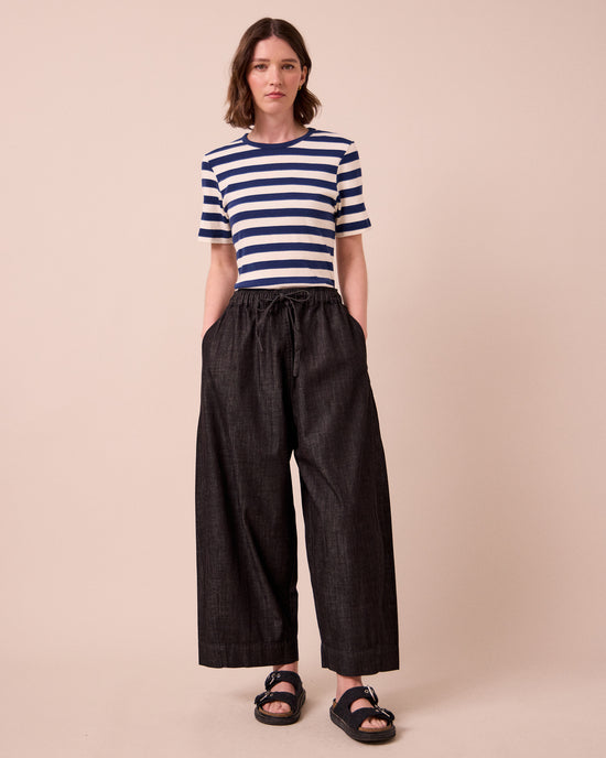 model wears mathilde washed black denim jeans right