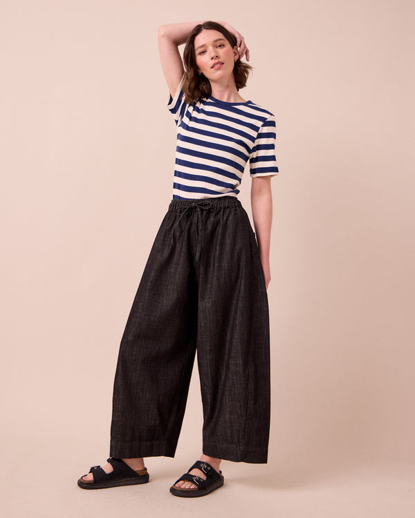 model wears mathilde washed black denim jeans left