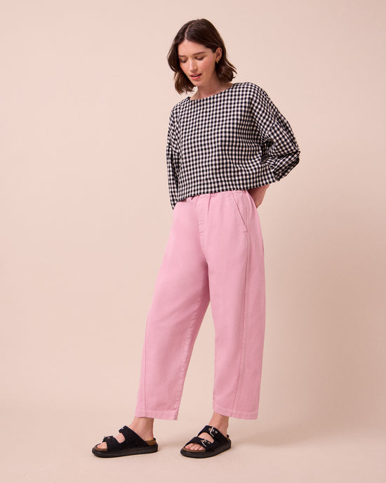 model wears maeve orchid pink denim jeans right