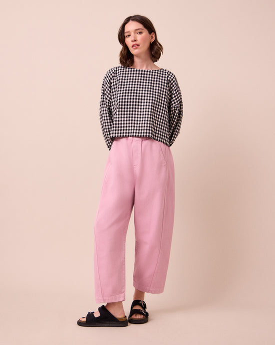 model wears maeve orchid pink denim jeans left