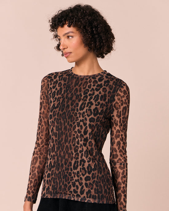 model wears dark leopard mesh top