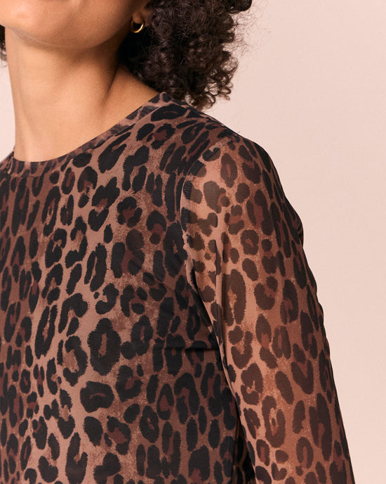 model wears dark leopard mesh top